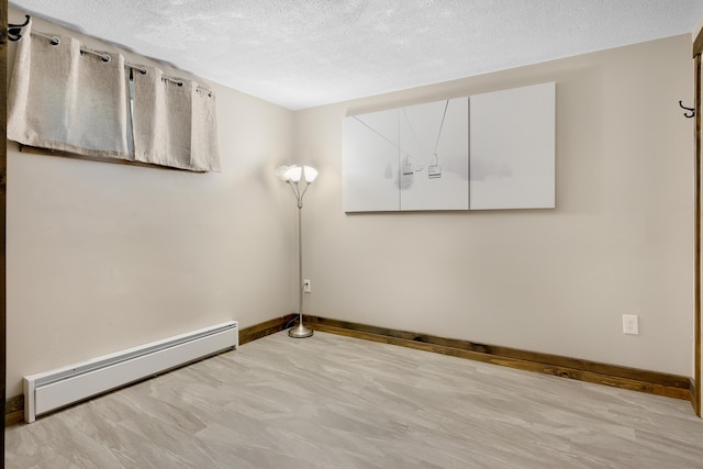 10 E Pinnacle Rd Unit 10, Bridgton, ME 04009 - unfurnished room with a baseboard radiator, baseboards, and a textured ceiling
