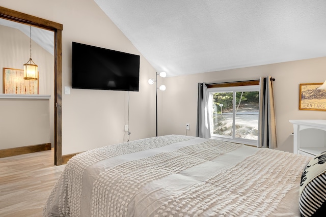 10 E Pinnacle Rd Unit 10, Bridgton, ME 04009 - bedroom with lofted ceiling, light wood finished floors, a textured ceiling, and baseboards