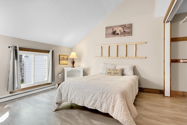 10 E Pinnacle Rd Unit 10, Bridgton, ME 04009 - bedroom with lofted ceiling, wood finished floors, a baseboard radiator, and baseboards