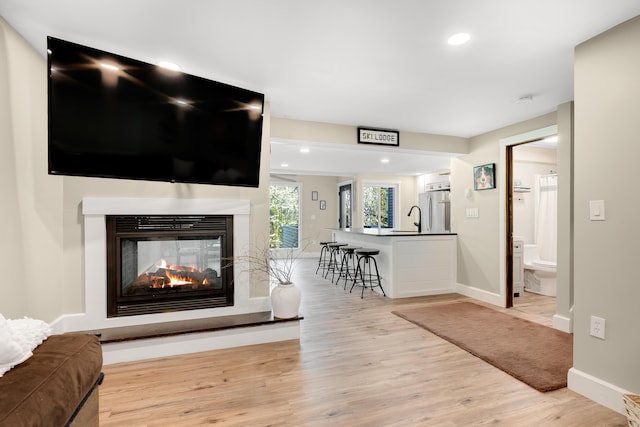 10 E Pinnacle Rd Unit 10, Bridgton, ME 04009 - living room featuring a multi sided fireplace, light wood finished floors, baseboards, and recessed lighting