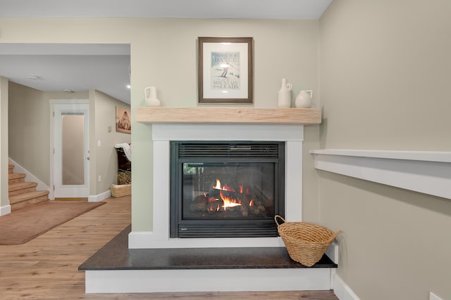 10 E Pinnacle Rd Unit 10, Bridgton, ME 04009 - detailed view of wood finished floors, a glass covered fireplace, and baseboards