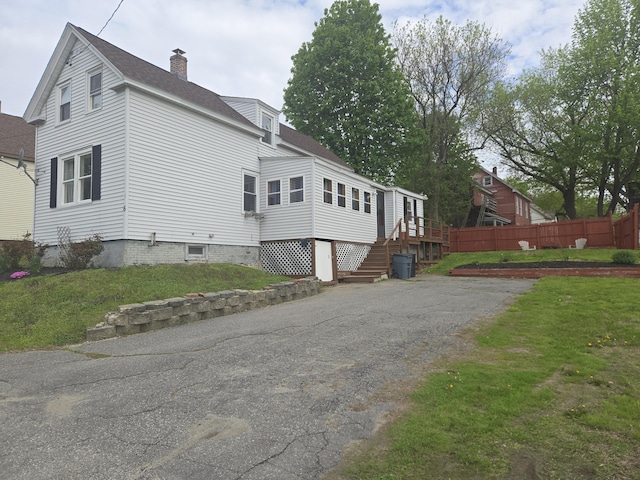 6 Linden St, Waterville, ME 04901 - view of home's exterior with a chimney, a shingled roof, and driveway
