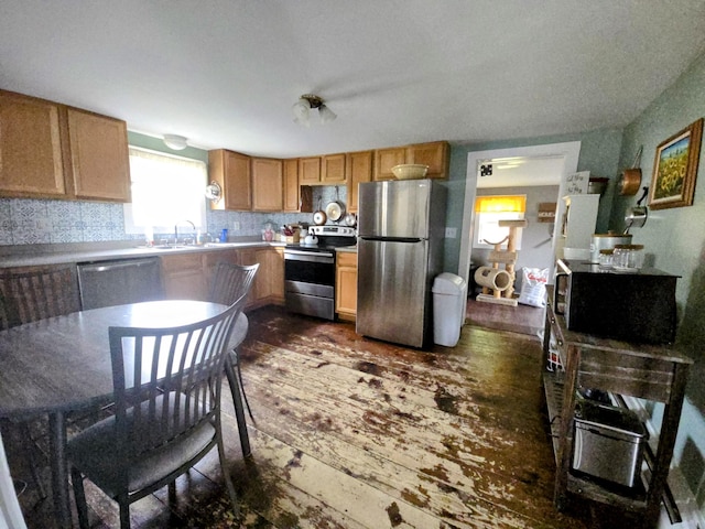 6 Linden St, Waterville, ME 04901 - kitchen with appliances with stainless steel finishes, dark wood-style floors, decorative backsplash, a sink, and light countertops