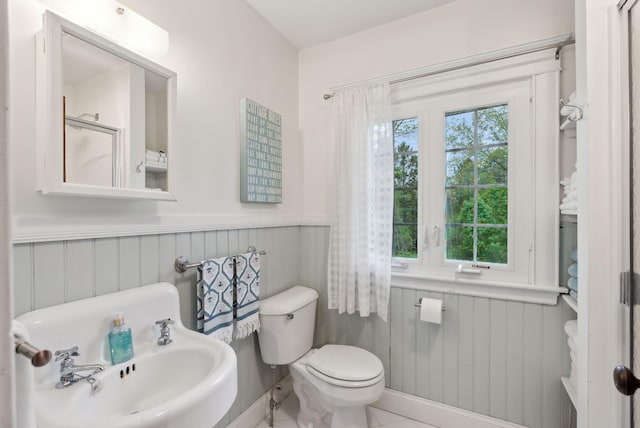 14 Oak St, Kennebunk, ME 04043 - bathroom featuring wainscoting, toilet, and a shower