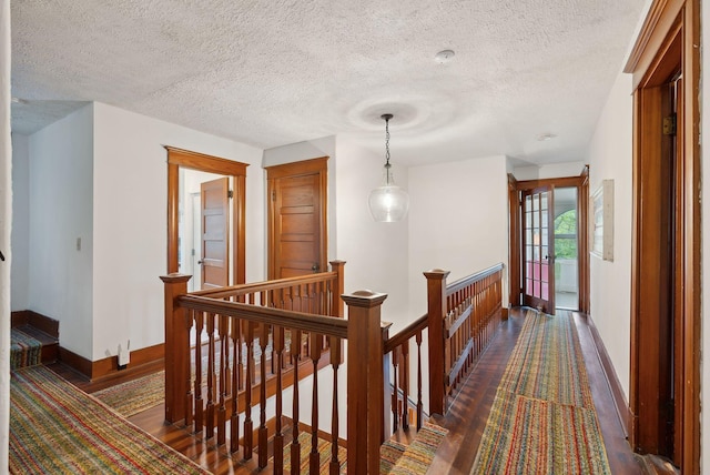 14 Oak St, Kennebunk, ME 04043 - corridor with an upstairs landing, dark wood-style floors, baseboards, and a textured ceiling