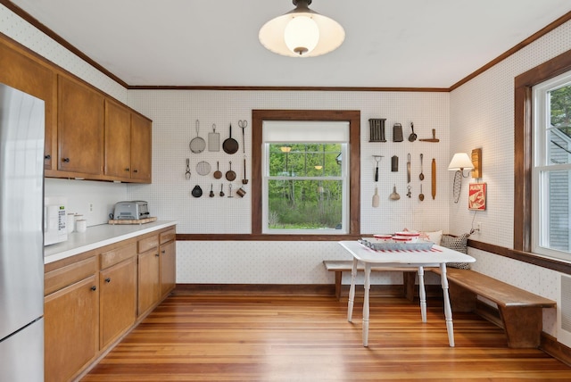 14 Oak St, Kennebunk, ME 04043 - kitchen with breakfast area, crown molding, wallpapered walls, light wood-style floors, and light countertops