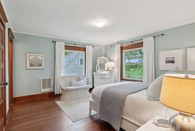 14 Oak St, Kennebunk, ME 04043 - bedroom featuring multiple windows, dark wood-type flooring, baseboards, heating unit, and crown molding