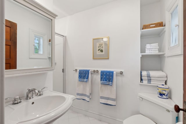 14 Oak St, Kennebunk, ME 04043 - bathroom with toilet, a sink, tile patterned floors, and baseboards