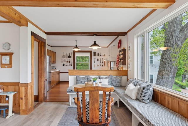 14 Oak St, Kennebunk, ME 04043 - living area with light wood-style floors, wainscoting, crown molding, beamed ceiling, and wooden walls