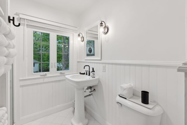 14 Oak St, Kennebunk, ME 04043 - bathroom with wainscoting, toilet, tile patterned floors, and a sink