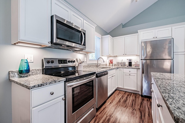 6 D St, Bridgton, ME 04009 - kitchen featuring appliances with stainless steel finishes, a sink, vaulted ceiling, white cabinets, and dark wood-type flooring