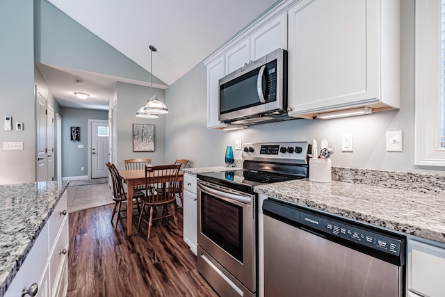 6 D St, Bridgton, ME 04009 - kitchen with appliances with stainless steel finishes, vaulted ceiling, white cabinets, dark wood-type flooring, and light stone counters