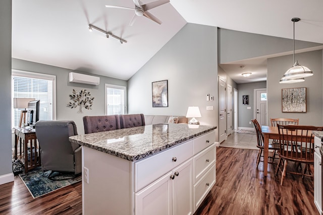 6 D St, Bridgton, ME 04009 - kitchen with a wall unit AC, a ceiling fan, dark wood-style floors, healthy amount of natural light, and high vaulted ceiling