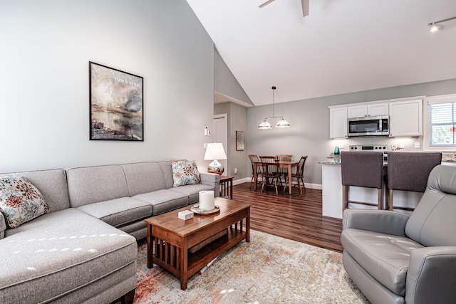 6 D St, Bridgton, ME 04009 - living room featuring light wood finished floors, ceiling fan, baseboards, and high vaulted ceiling