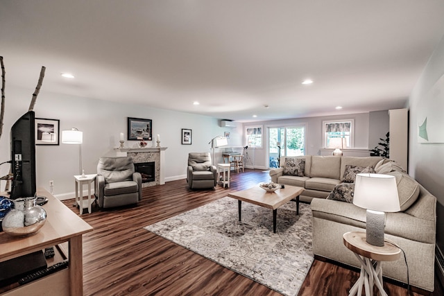 6 D St, Bridgton, ME 04009 - living room featuring dark wood-style floors, recessed lighting, a glass covered fireplace, baseboards, and a wall unit AC