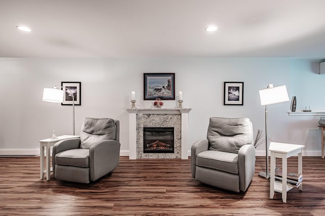 6 D St, Bridgton, ME 04009 - sitting room with wood finished floors, recessed lighting, a glass covered fireplace, baseboards, and an AC wall unit