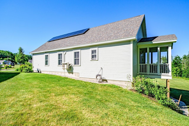 6 D St, Bridgton, ME 04009 - view of side of property with a yard, a shingled roof, roof mounted solar panels, and a sunroom