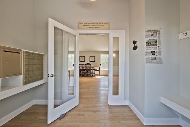 6 D St, Bridgton, ME 04009 - hall featuring wood finished floors, mail area, and baseboards