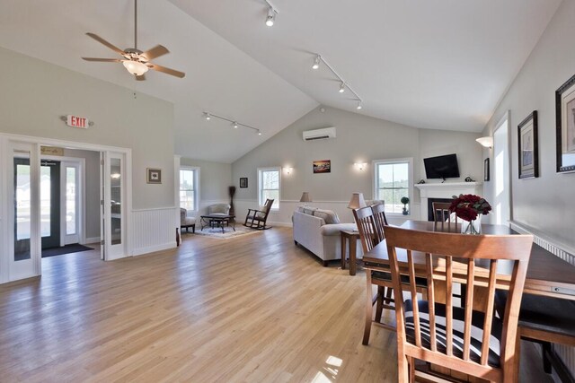 6 D St, Bridgton, ME 04009 - dining space with rail lighting, a wall mounted AC, light wood-style flooring, ceiling fan, and high vaulted ceiling