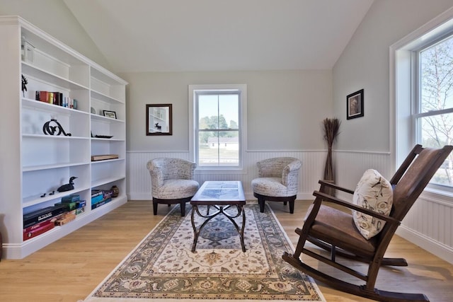 6 D St, Bridgton, ME 04009 - living area with wainscoting, lofted ceiling, and light wood-style floors