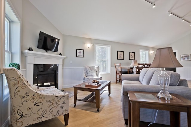 6 D St, Bridgton, ME 04009 - living room with lofted ceiling, track lighting, healthy amount of natural light, light wood-style floors, and a fireplace