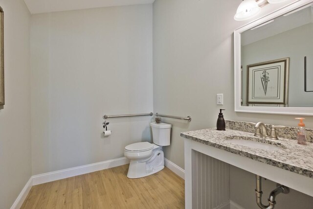 6 D St, Bridgton, ME 04009 - half bath featuring a sink, wood finished floors, baseboards, and toilet