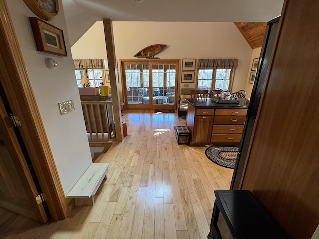 hallway featuring lofted ceiling and light wood-type flooring