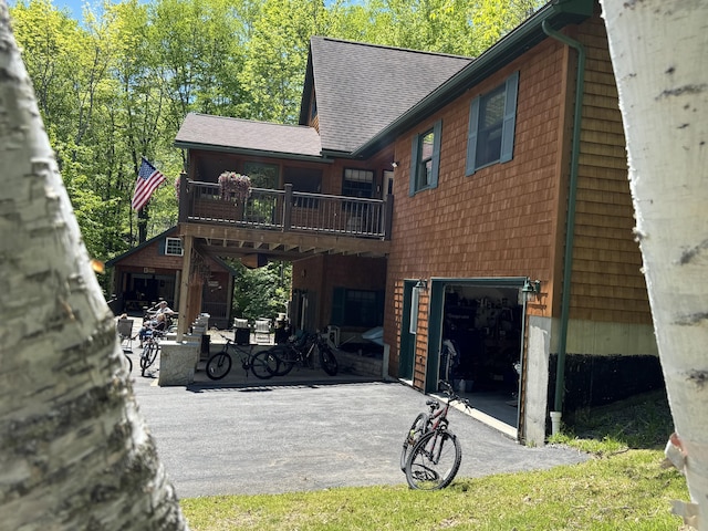 11 Cherry Dr, Embden, ME 04958 - rear view of house with an attached garage, asphalt driveway, and a shingled roof