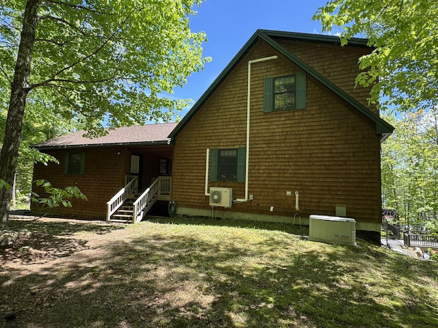 11 Cherry Dr, Embden, ME 04958 - back of house with ac unit and a lawn