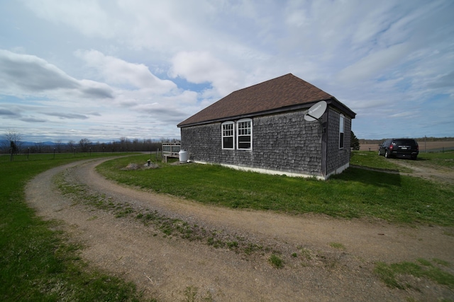 899 Golden Ridge Rd, Sherman, ME 04476 - view of side of home featuring a yard, a shingled roof, and dirt driveway