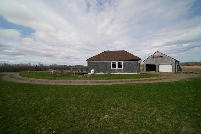 899 Golden Ridge Rd, Sherman, ME 04476 - view of side of home with an outdoor structure, a yard, and a garage