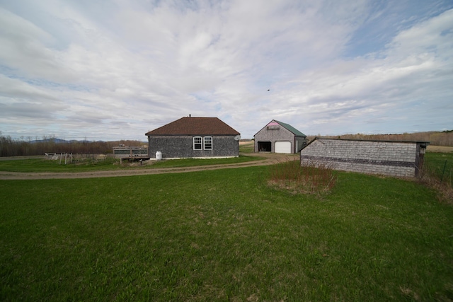 899 Golden Ridge Rd, Sherman, ME 04476 - view of green lawn featuring an outdoor structure and a garage