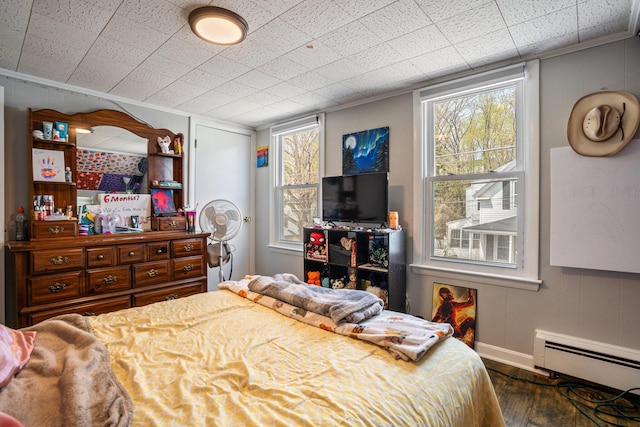 31 King St, Waterville, ME 04901 - bedroom featuring baseboard heating, wood finished floors, baseboards, multiple windows, and crown molding