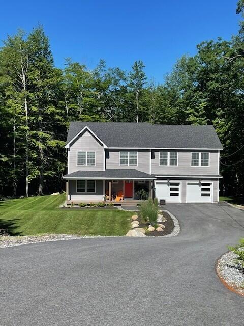 26 John Adams Ct, Naples, ME 04055 - view of front of home featuring asphalt driveway, an attached garage, and a front yard