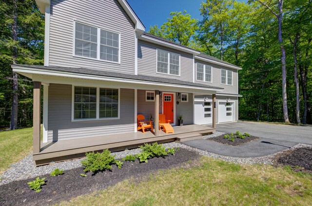 26 John Adams Ct, Naples, ME 04055 - view of front of home featuring covered porch, asphalt driveway, and a garage