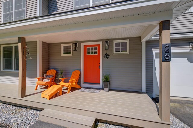 26 John Adams Ct, Naples, ME 04055 - view of exterior entry with covered porch and a garage