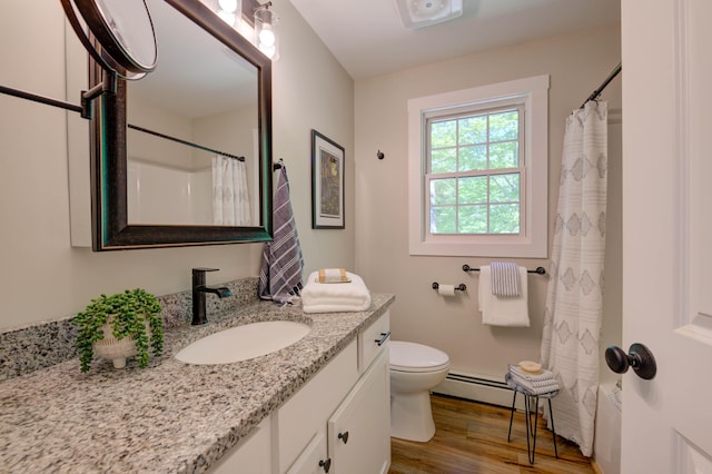 26 John Adams Ct, Naples, ME 04055 - full bath featuring vanity, wood finished floors, toilet, a baseboard radiator, and a shower with shower curtain