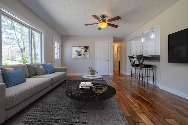 46 Silver Rdg, Veazie, ME 04401 - living area with a ceiling fan, dark wood-style flooring, a textured ceiling, and baseboards