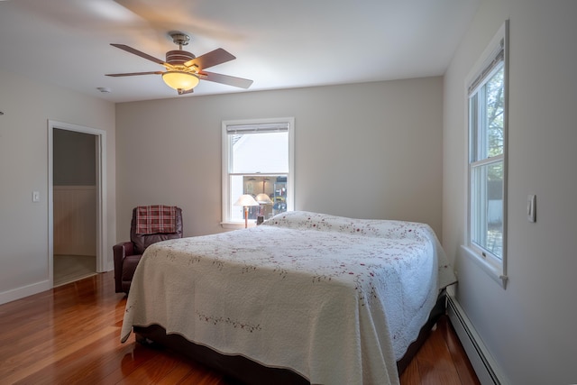 46 Silver Rdg, Veazie, ME 04401 - bedroom featuring baseboard heating, wood finished floors, baseboards, and a ceiling fan