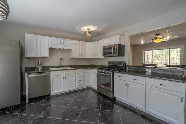 46 Silver Rdg, Veazie, ME 04401 - kitchen with appliances with stainless steel finishes, a sink, white cabinetry, dark tile patterned floors, and dark stone counters
