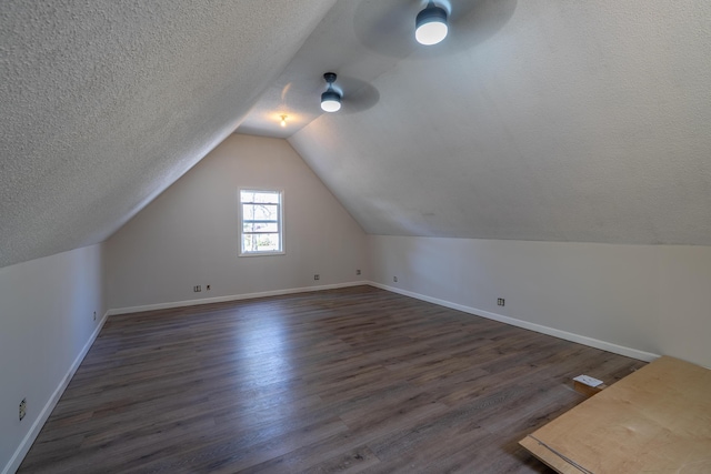 46 Silver Rdg, Veazie, ME 04401 - additional living space featuring baseboards, dark wood finished floors, vaulted ceiling, and a textured ceiling