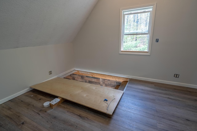 46 Silver Rdg, Veazie, ME 04401 - bonus room with vaulted ceiling, wood finished floors, baseboards, and a textured ceiling