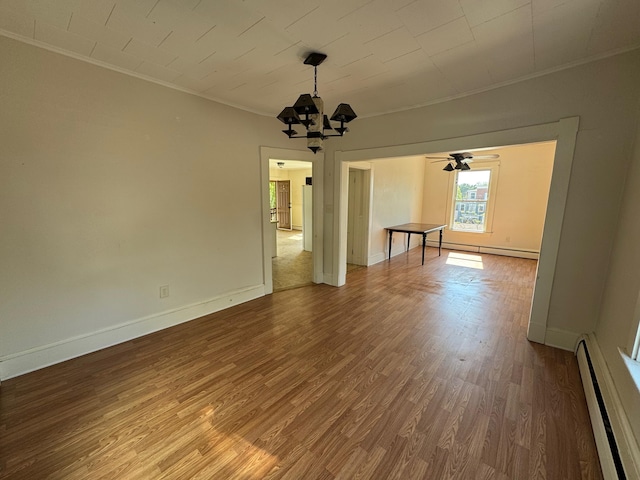 932 Lisbon St, Lewiston, ME 04240 - unfurnished dining area with crown molding, a baseboard radiator, wood finished floors, a chandelier, and baseboards