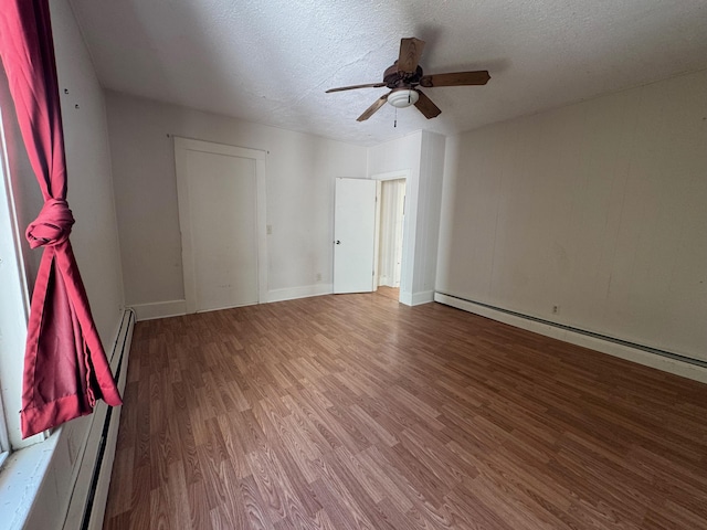 932 Lisbon St, Lewiston, ME 04240 - spare room with wood finished floors, a ceiling fan, a baseboard radiator, a textured ceiling, and baseboards