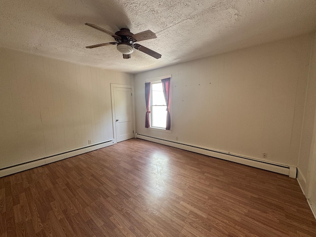 932 Lisbon St, Lewiston, ME 04240 - unfurnished room featuring baseboard heating, wood finished floors, a ceiling fan, and a textured ceiling