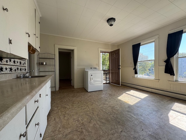 932 Lisbon St, Lewiston, ME 04240 - kitchen featuring washer / dryer, a baseboard heating unit, white cabinets, a wainscoted wall, and tile patterned floors