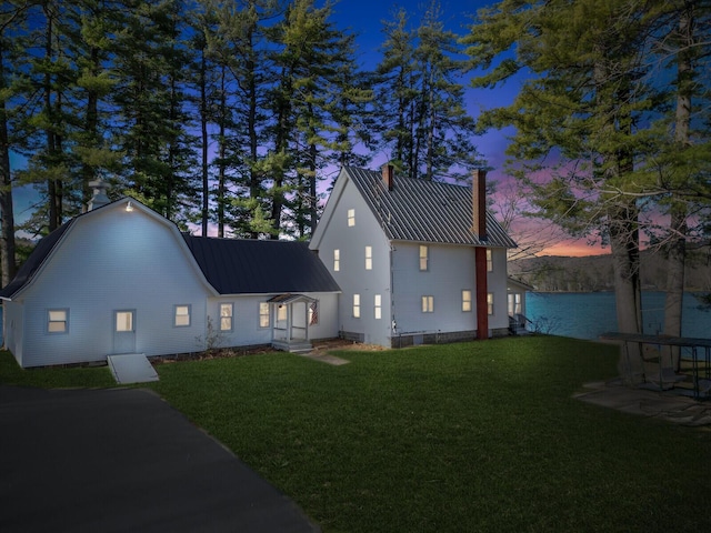 112 Buker Rd, Litchfield, ME 04350 - view of side of property featuring a chimney, metal roof, and a lawn