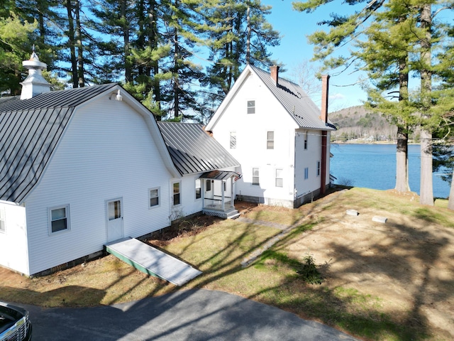 112 Buker Rd, Litchfield, ME 04350 - view of side of home with a chimney, a standing seam roof, metal roof, and a water view