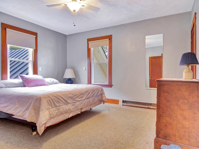 112 Buker Rd, Litchfield, ME 04350 - bedroom with a baseboard radiator, carpet, baseboards, and ceiling fan
