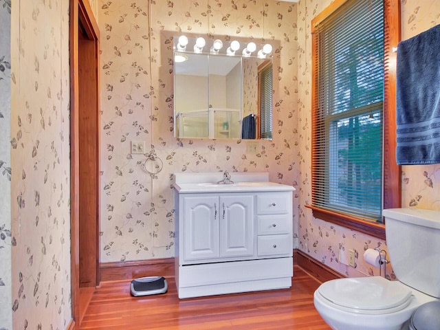 112 Buker Rd, Litchfield, ME 04350 - full bathroom featuring wallpapered walls, wood finished floors, baseboards, toilet, and vanity